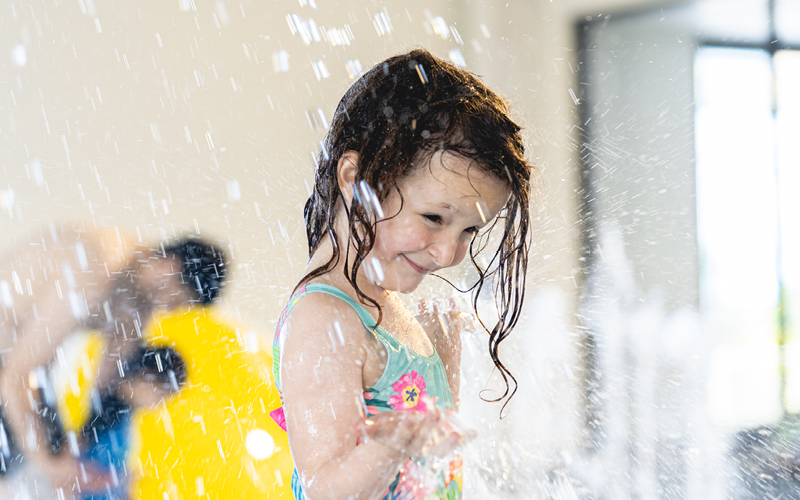 Photo of kid playing in water 